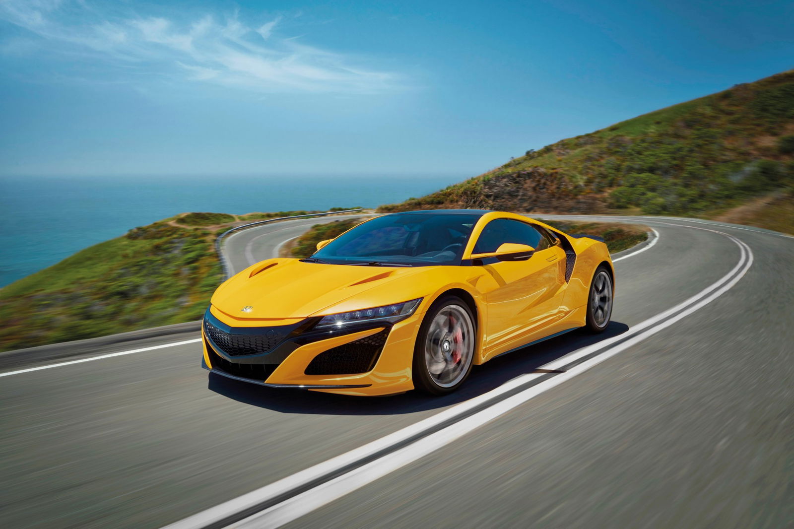 Honda NSX 2020, gialla, vista tre quarti anteriore in movimento fra le curve